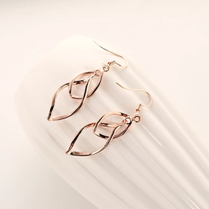 Elegant rose gold celtics style earrings with twisted leaf design on white texture