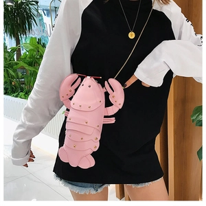Detailed close-up of a pink lobster shaped PU leather crossbody bag with gold chain strap