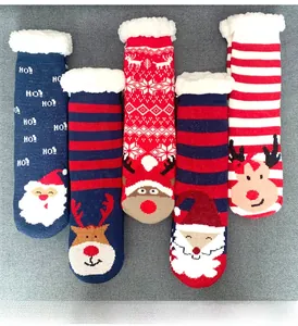 Detail of five pairs of thick Christmas fleece socks with reindeer and snowflake patterns