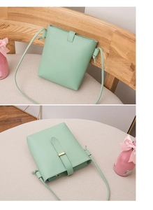Close-up of mint green bucket bag with lychee grain leather and golden metal clasp