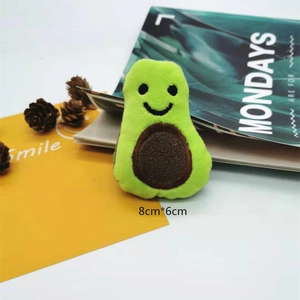 Close-up of cute plush avocado brooch with smiling face for bag and scarf accessory
