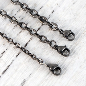 Close-up of vintage gun-black stainless steel snake bone chains with lobster clasps