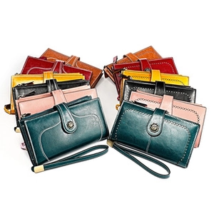 Macro view of multi-color long leather wallets with metal clasps and matching wrist straps