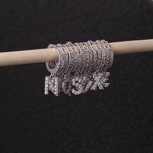 Silver letter hoop earrings featuring cubic zirconia charms for a sparkling jewelry look