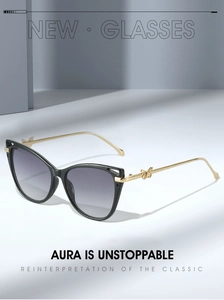 Detail of cat-eye sunglasses featuring golden butterfly motifs on slim metal temples
