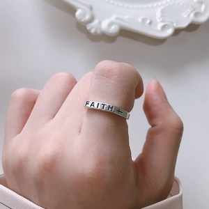 Minimalist 925 sterling silver ring featuring FAITH engraving and cross symbol on finger