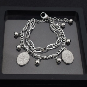 Double-layered stainless steel bracelet with cross beads and Virgin Mary charms in a tray