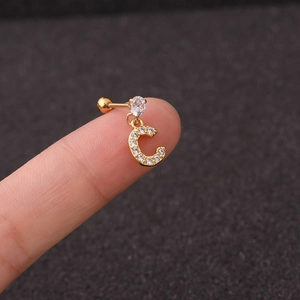 Detail of a gold stainless steel letter C stud earring with sparkling cubic zirconia