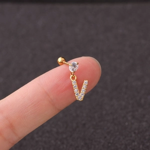 Macro shot of gold V letter earring with zircon inlay showing screw back ball and size