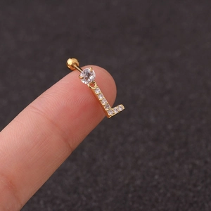 Detail of gold zircon ear stud with letter L pendant and screw ball backing