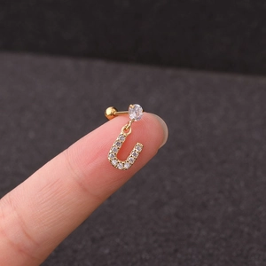 Macro shot of gold stainless steel horseshoe cartilage stud with sparkling zircon stones