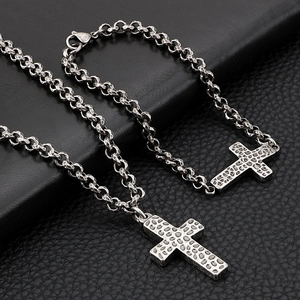 Retro stainless steel cross pendant necklace with textured finish on black leather background