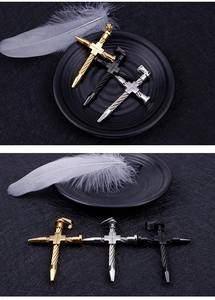 Detailed close-up of three titanium steel cross pendants in gold, silver, and black finish
