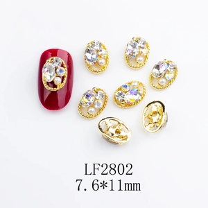 Detail of 7.6*11mm gold alloy nail art charm with oval hollow frame and rhinestones