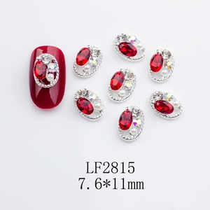 Detailed view of red oval nail charms with hollow alloy frame and crystals
