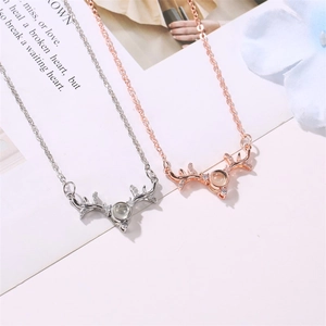 Antler projection necklace in silver and rose gold with rhinestone-encrusted deer horn