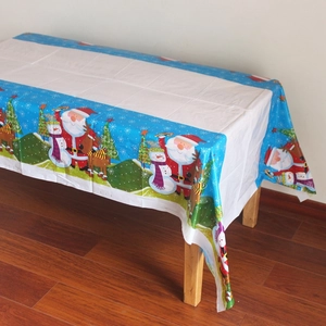 Détail de nappe de Noël avec motifs de Père Noël, bonhomme de neige et de renne