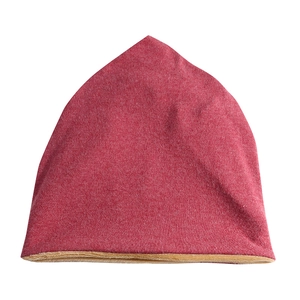 Detailed view of red knitted beanie with warm beige fleece lining for winter insulation