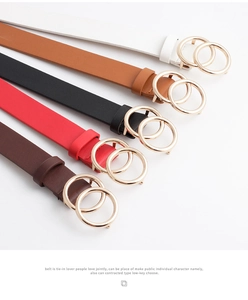 Detail of five slim faux leather belts with vintage gold double ring buckles in various colors