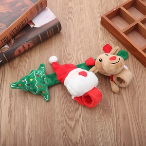 Detailed view of Christmas slap bracelets featuring Santa, tree, and reindeer plushies