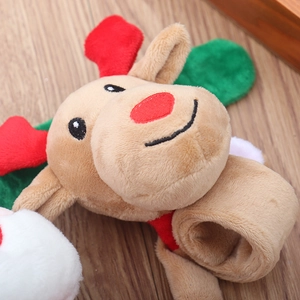 Close-up of reindeer plush snap bracelet with soft tan fabric and festive red antlers