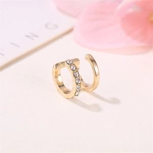 Minimalist double layer gold ear cuff with white rhinestones on a decorative floral background