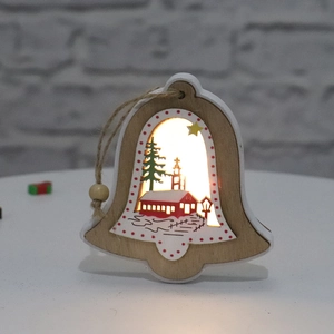 Close-up of wood bell ornament with glowing LED lights and painted winter scene