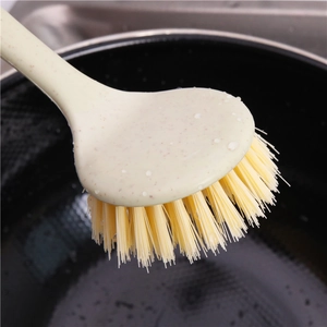 Long handle kitchen dish brush made of wheat straw with water droplets on yellow bristles