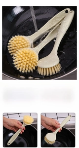 Close-up of long-handled kitchen brush with dense round bristles for pot cleaning