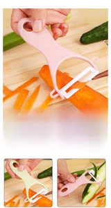 Close-up of Y-shaped ceramic vegetable peeler for potatoes and carrots with hanging hole