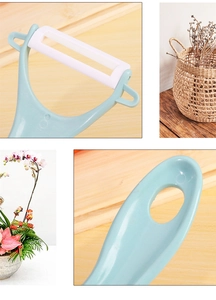Detailed close-up of light blue ceramic peeler handle and white blade holder