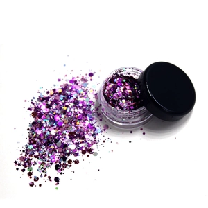 Cosmetic purple glitter jar detail shot, holographic festival face makeup sequin.