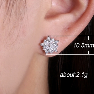 Sparkling zircon snowflake earrings on model showing 10.5mm size and elegant silver finish
