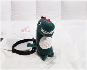 Close-up of cute green plush dinosaur crossbody bag with soft fur and adjustable strap