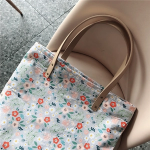Elegant floral canvas tote bag with daisy patterns and brown leather straps for women