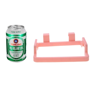 Pink plastic over-the-cabinet door trash bag holder with standard can for size reference