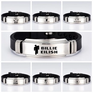 Detail of Billie Eilish silicone wristbands with stainless steel and engraved logos