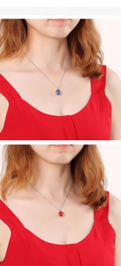 Detail showing minimalist silver chain necklaces with square blue and red crystal pendants