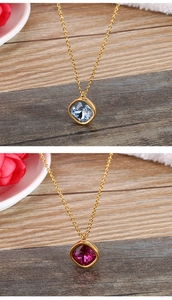 Macro detail of 13mm square cut zircon crystal pendant on a thin gold chain