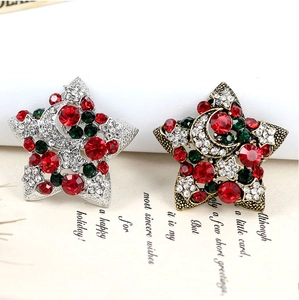 Detail of Christmas star brooches with colorful rhinestones on festive gift cards
