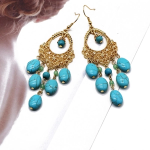 Detail showing vintage bohemian tassel earrings with turquoise beads and gold alloy metalwork