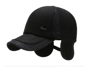 Detail view of winter baseball cap with ear protection and silver Sport metal badge