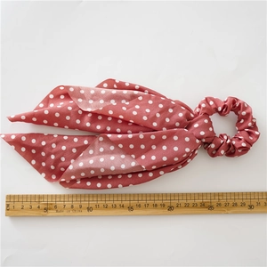 Polka dot hair scrunchie with long ribbon in red and white fabric, length 30cm shown with ruler