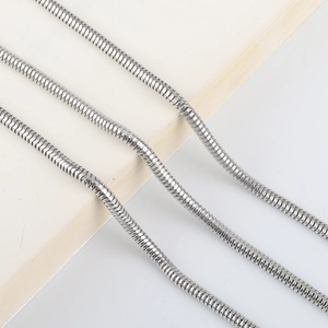 Detailed macro view of the silver snake chain texture and tight metallic link weaving