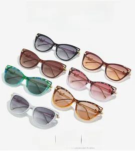 Flat lay of trendy cat-eye sunglasses with metal frames in multiple colors and patterns