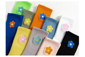 Detail shot of assorted cotton mid-calf socks with colorful floral embroidery accents