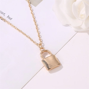 Detailed close-up of a golden metal padlock pendant necklace on a clean white background