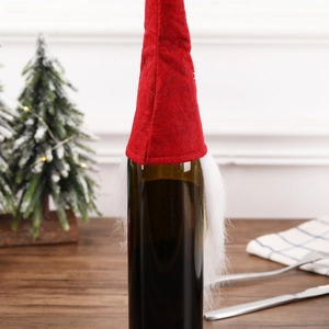 Handmade red gnome Christmas wine bottle cover with white faux fur beard and hat