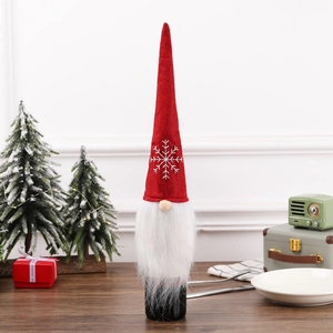 Christmas gnome wine bottle cover with red snowflake hat and white faux fur beard