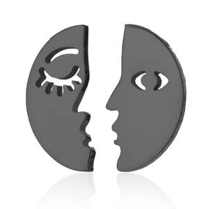 Detailed view of hollow asymmetrical face earrings in gunmetal grey finish
